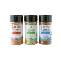 Three bottles of Little Palates Organic Spices on a white background: Apple Cinnamon, Herb Garden, and Baby-Q.